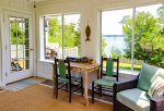 Sunroom with water views and access to the deck
